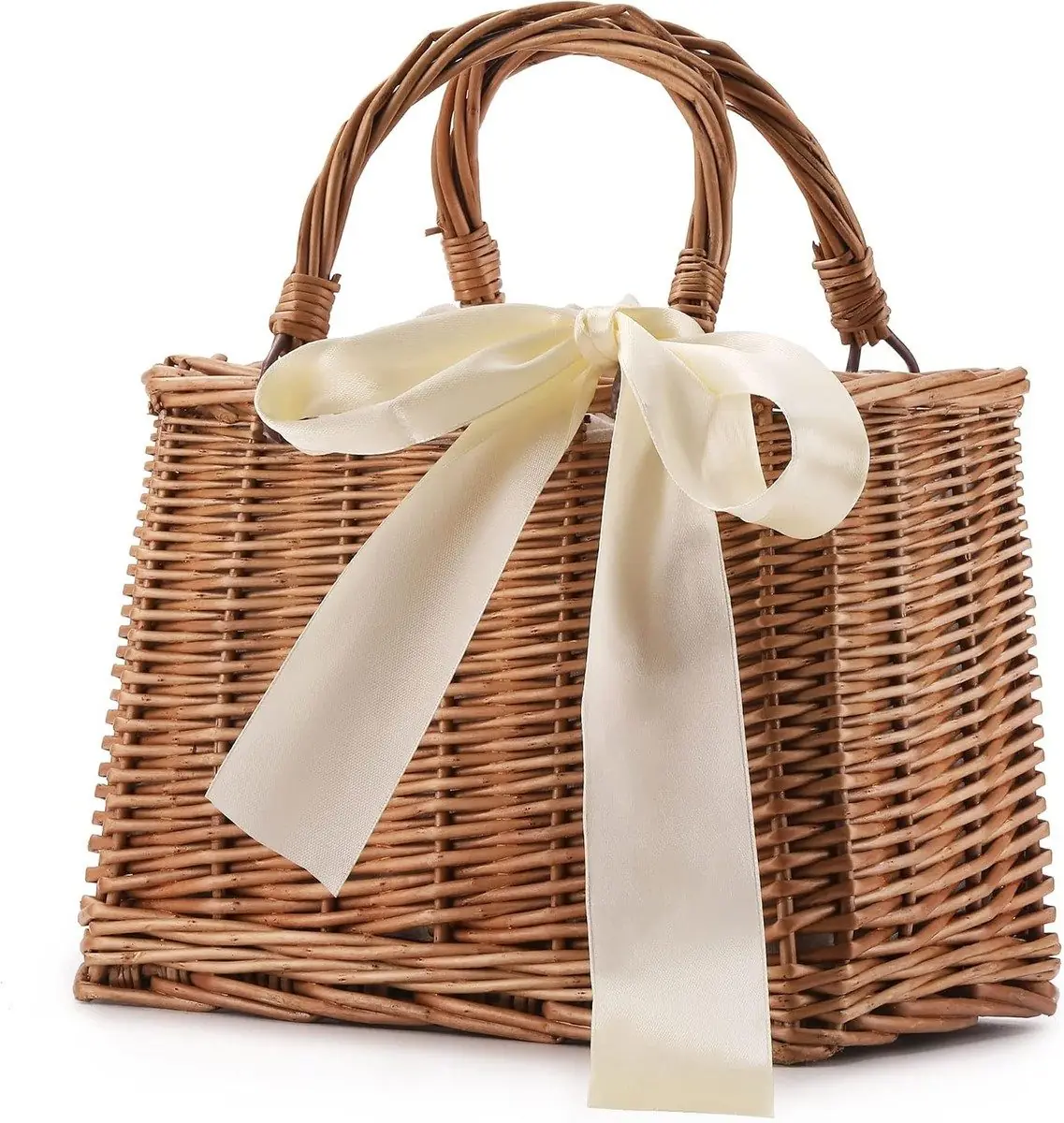 Wicker-woven rattan basket bag with wrapped handles and a satin bow, photographed on a plain background
